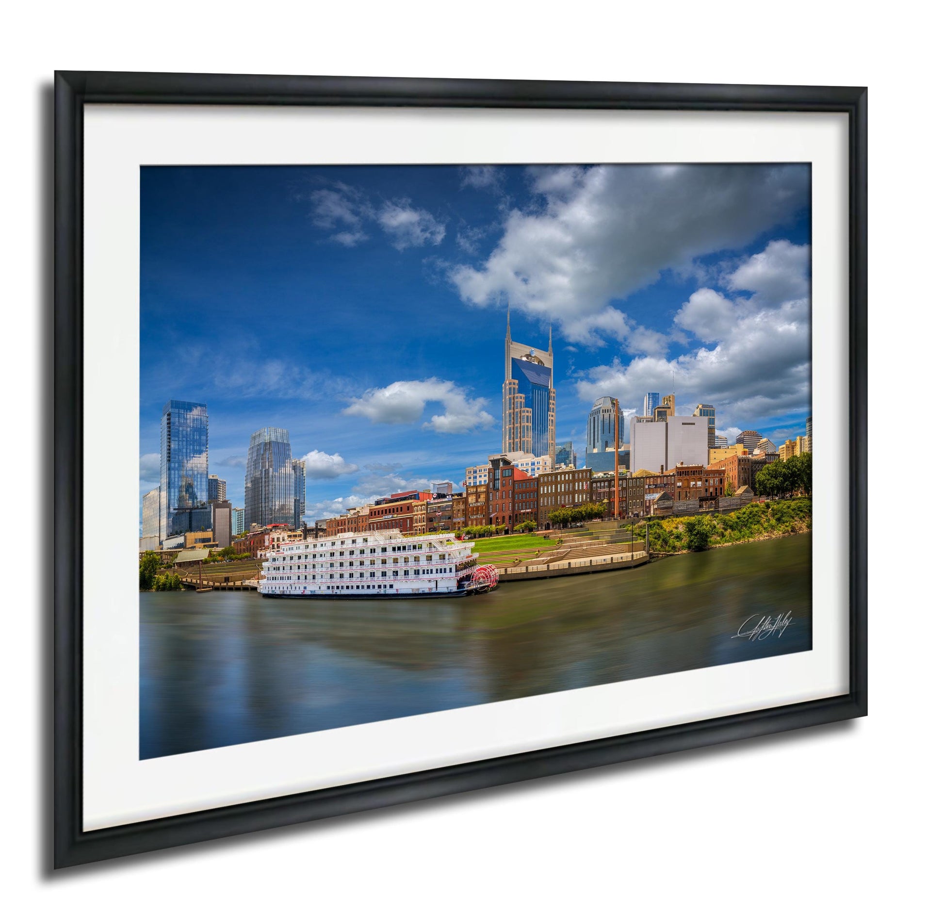 a cityscape with a river running through it, featuring a large white boat on the water. The city skyline includes tall buildings and skyscrapers, creating a vibrant and bustling urban environment.