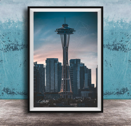 A framed photograph of the Space Needle, a famous landmark in Seattle, Washington, with the city skyline in the background.