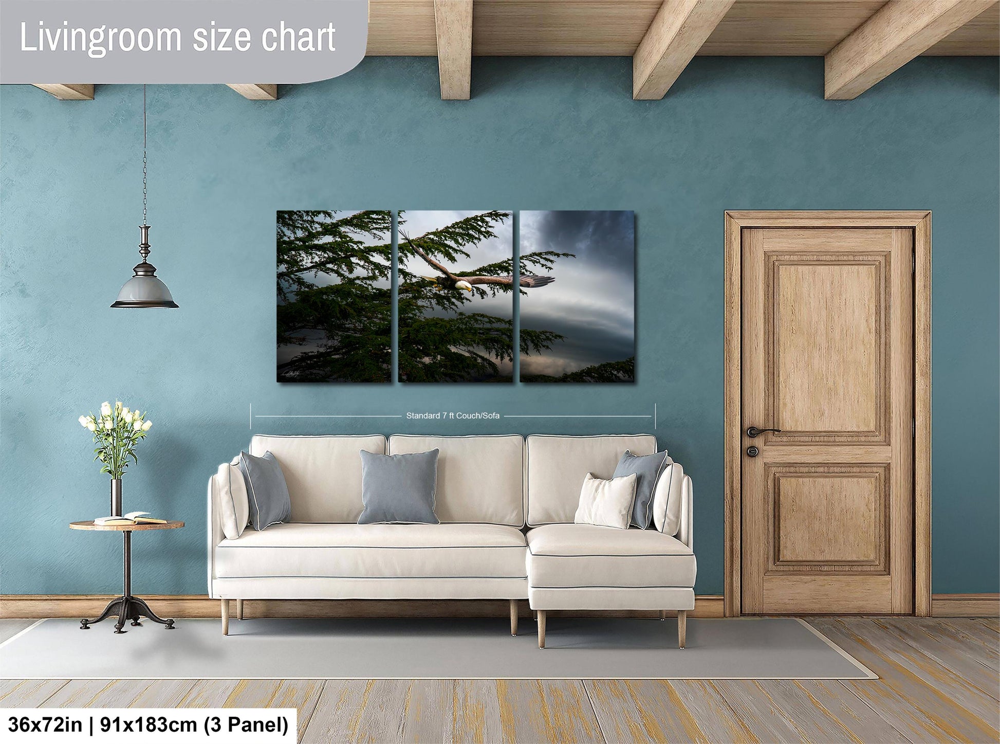 The image is a living room with a white sofa, a wooden door, and a painting of a tree on the wall.