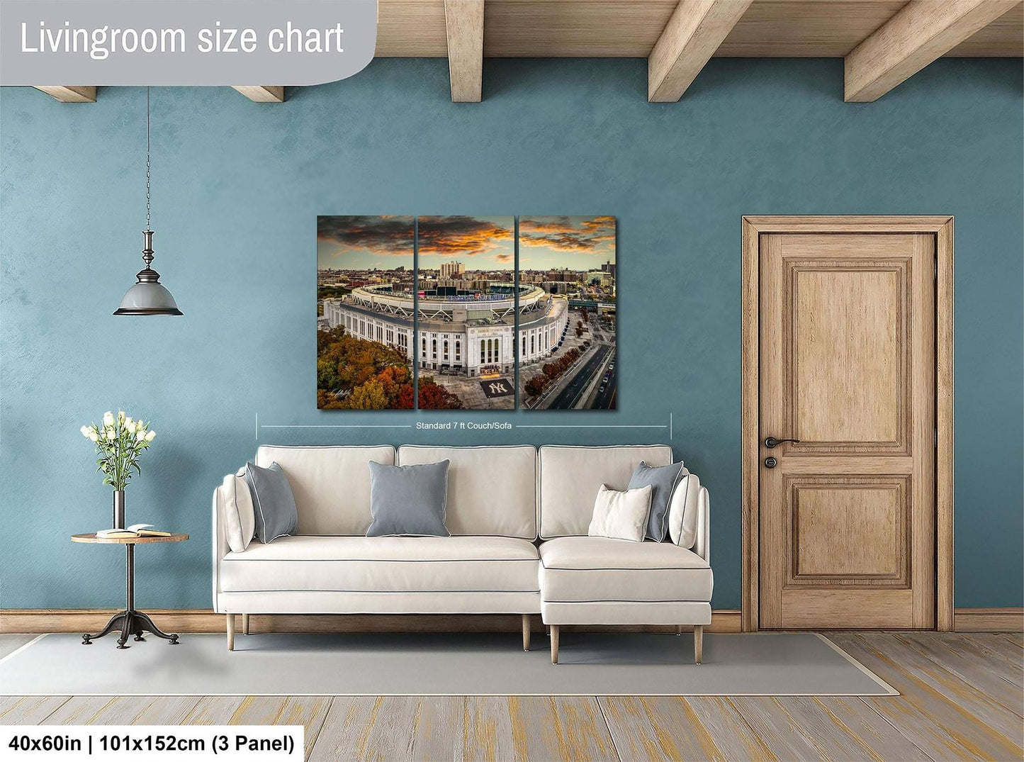 The image is a living room with a large white sofa, a wooden door, and a painting of a cityscape hanging on the wall.