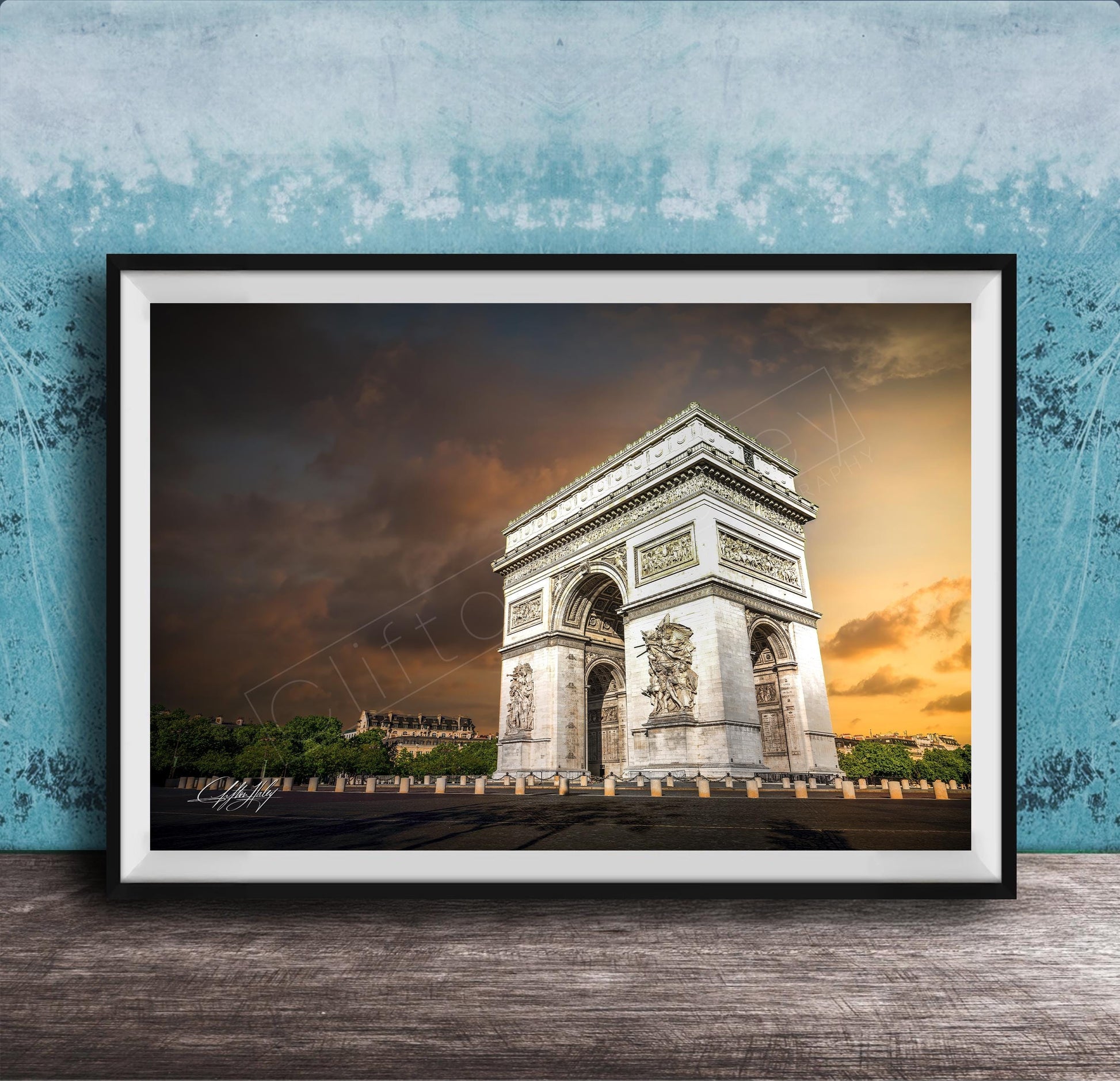 a large, ornate archway with intricate carvings, set against a dramatic sky with clouds and a warm, orange glow.