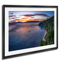 A serene landscape with a calm lake, a sailboat on the water, and a picturesque sunset over the horizon.