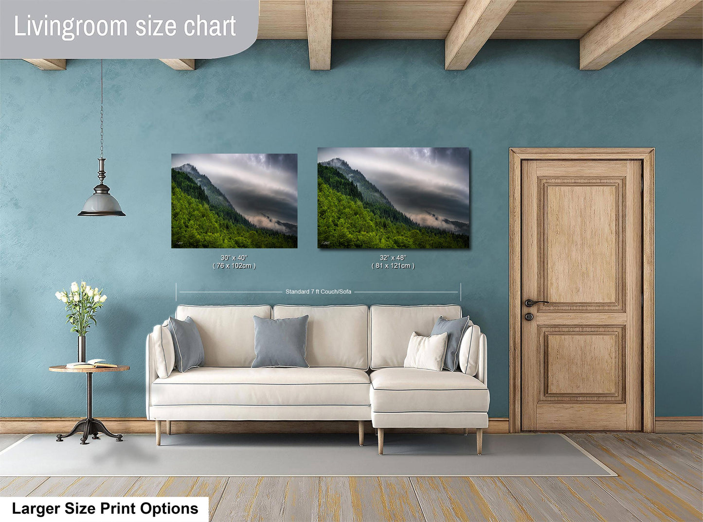 a living room with a white sofa, a wooden door, and a painting of a mountain landscape on the wall.