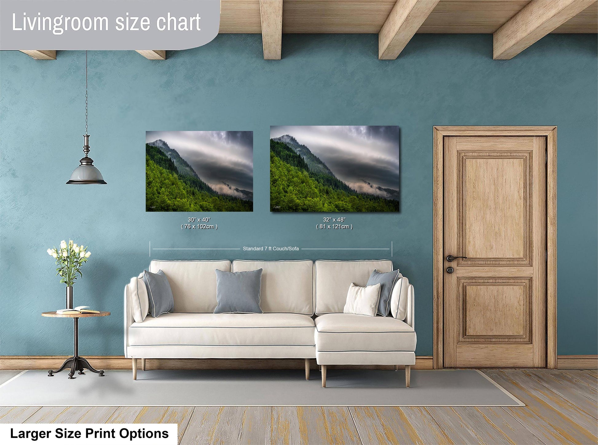 a living room with a white sofa, a wooden door, and a painting of a mountain landscape on the wall.
