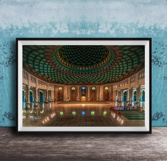 a grand, ornate mosque with a large, domed ceiling and intricate tile work. The interior features a central courtyard surrounded by arched doorways and windows, creating a sense of spaciousness and elegance.