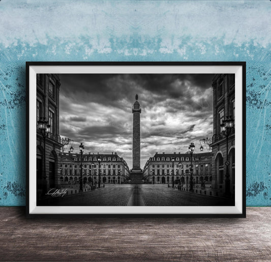 A black and white photograph of the Eiffel Tower in Paris, France, with a cloudy sky in the background.