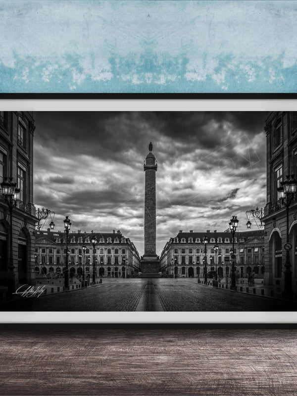 A black and white photograph of the Eiffel Tower in Paris, France, with a cloudy sky in the background.