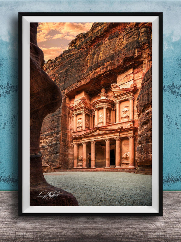 A framed photograph of the ancient ruins of Petra, a famous archaeological site in Jordan, featuring the iconic Treasury of the Kings carved into the rock face.
