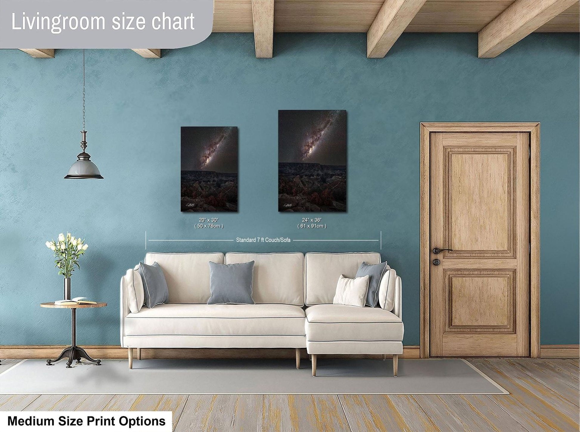 a living room with a white sofa, a wooden door, and two framed pictures hanging on the wall.