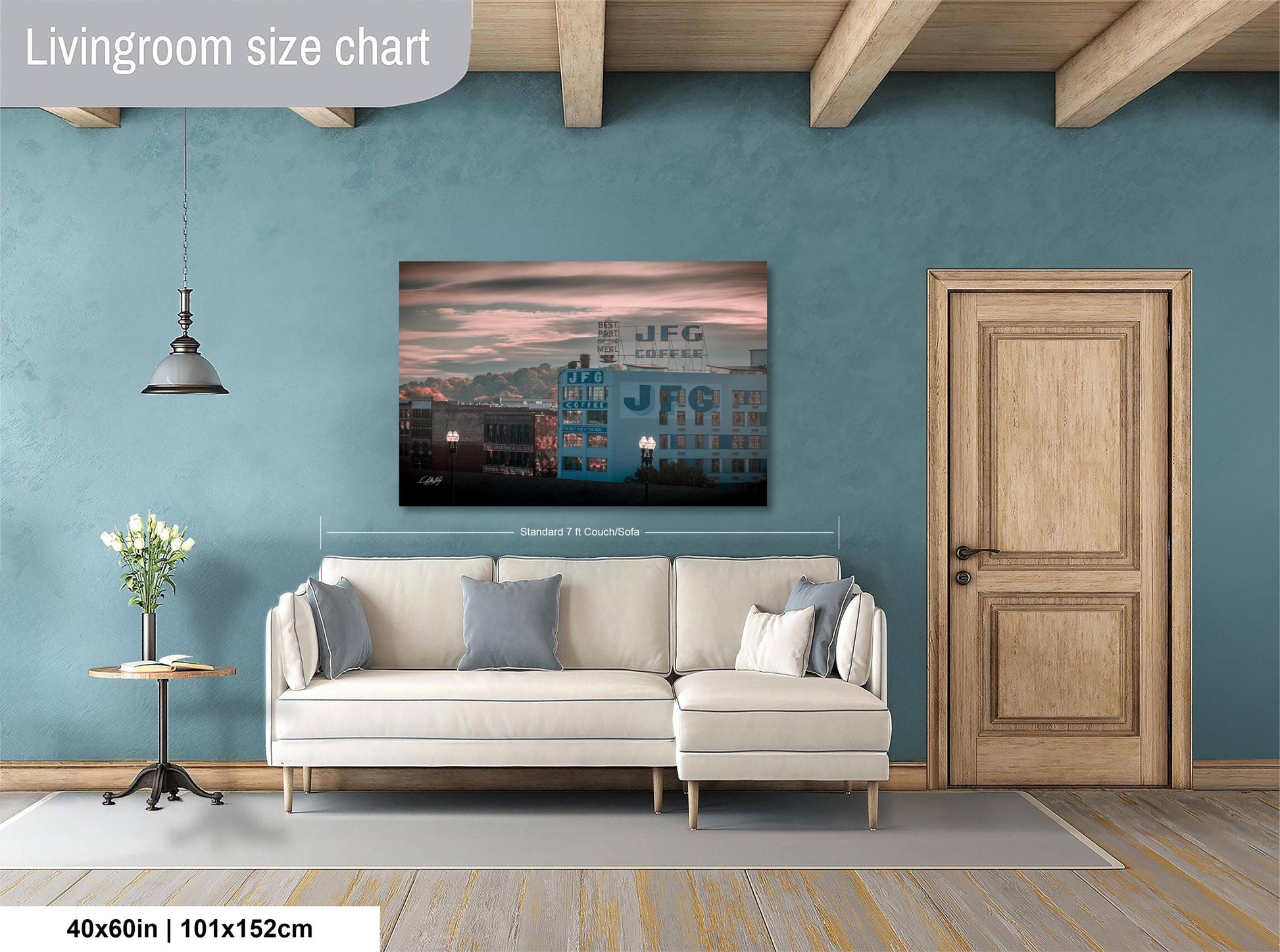 a living room with a white sofa, a wooden door, and a large wall painting depicting a cityscape.