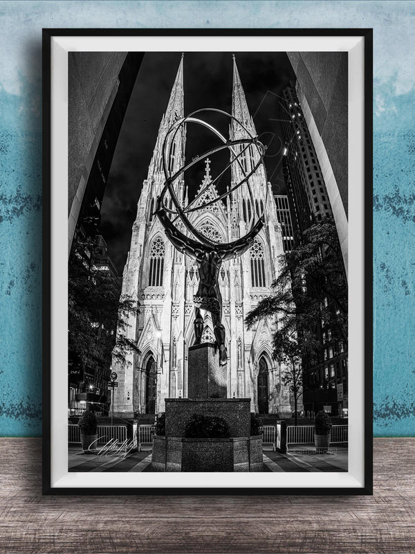 A black and white photograph of a large cathedral with a statue of a man on a pedestal in the foreground, set against a blue wall.