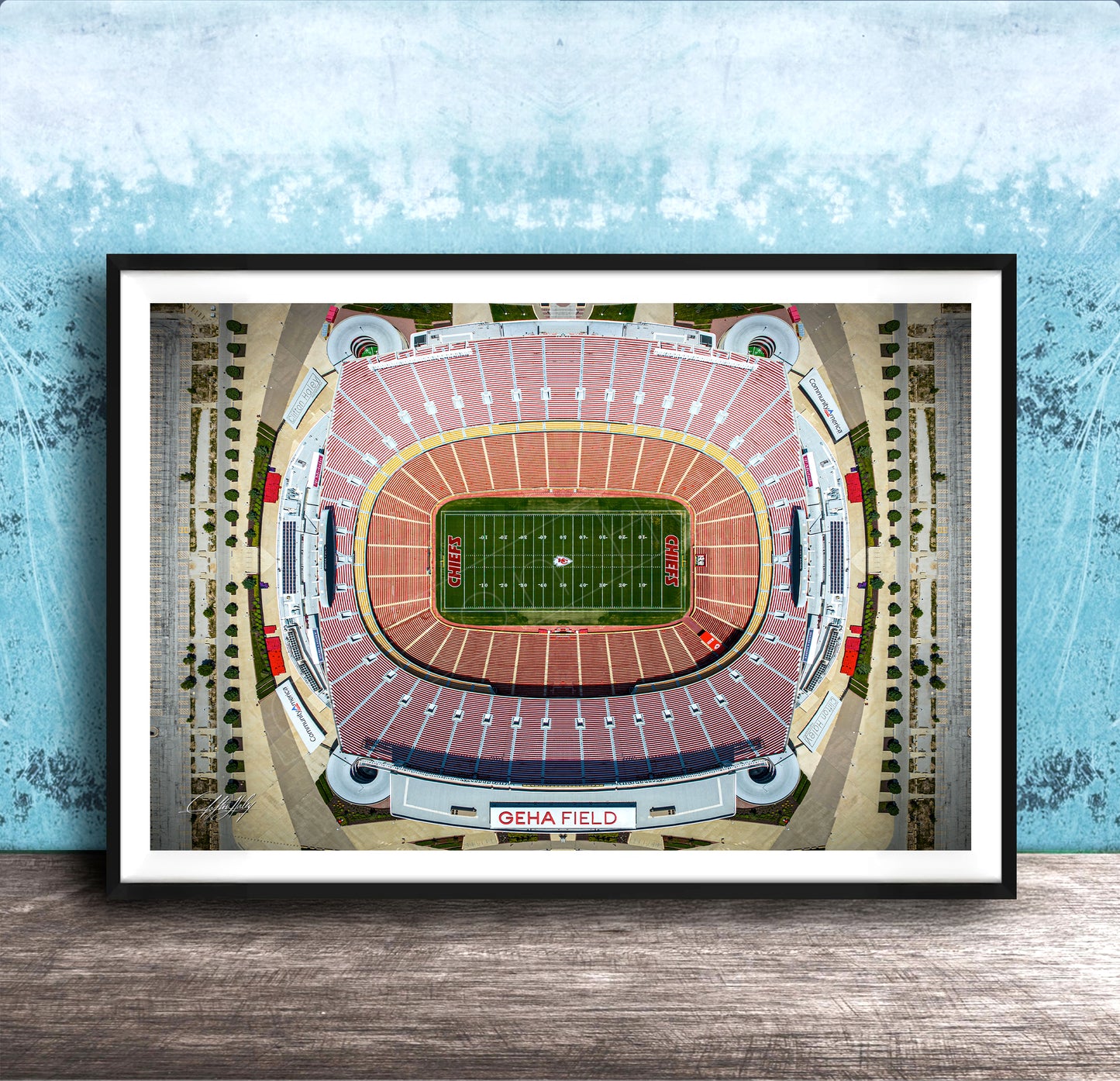 The image is an aerial view of a football stadium, specifically GEHA Field, with a focus on the field and surrounding infrastructure.