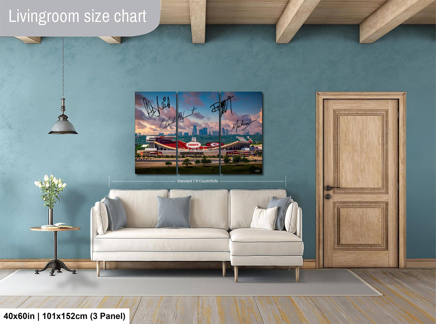 The image is a living room with a large white sofa, a wooden door, and a painting of a stadium on the wall.