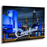 A nighttime cityscape of Cleveland, Ohio, with the Cleveland Museum of Art and the Cleveland Clinic prominently featured. The city skyline is illuminated with colorful lights, creating a vibrant and lively atmosphere.