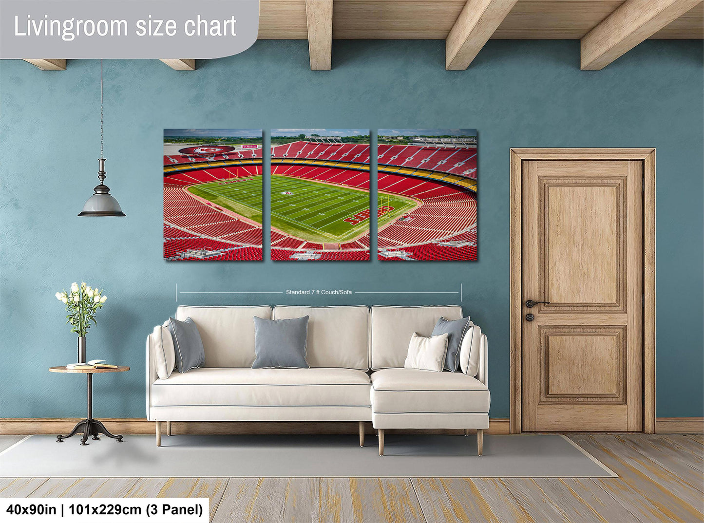 The image is a living room with a large wall art depicting a football stadium. The wall art is divided into three panels, each showing different parts of the stadium. The living room has a white sofa and a wooden door.