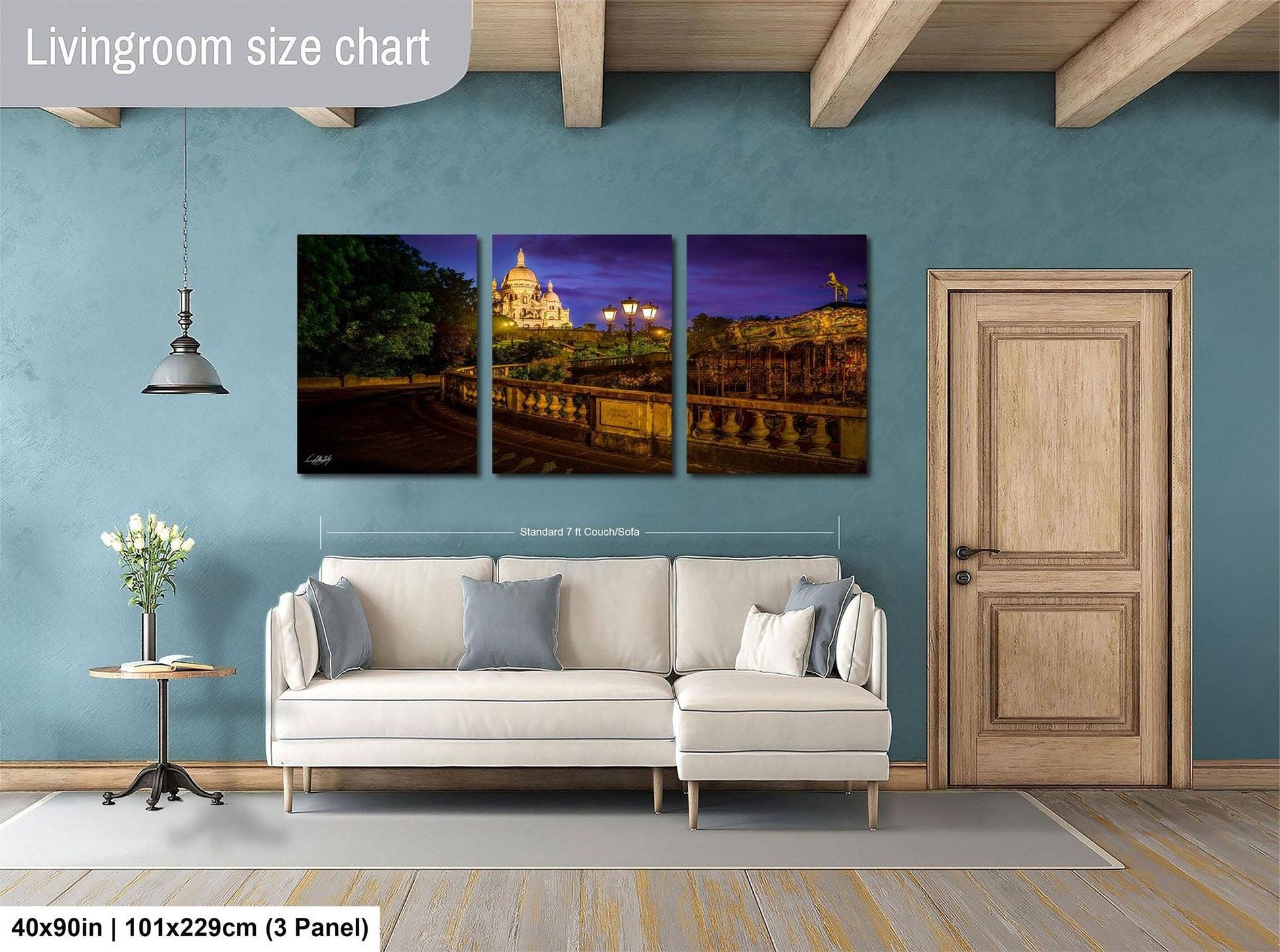 The image is a living room with a white sofa and a wooden door. Above the sofa, there is a large living room size chart that provides dimensions for the artwork displayed on the wall.