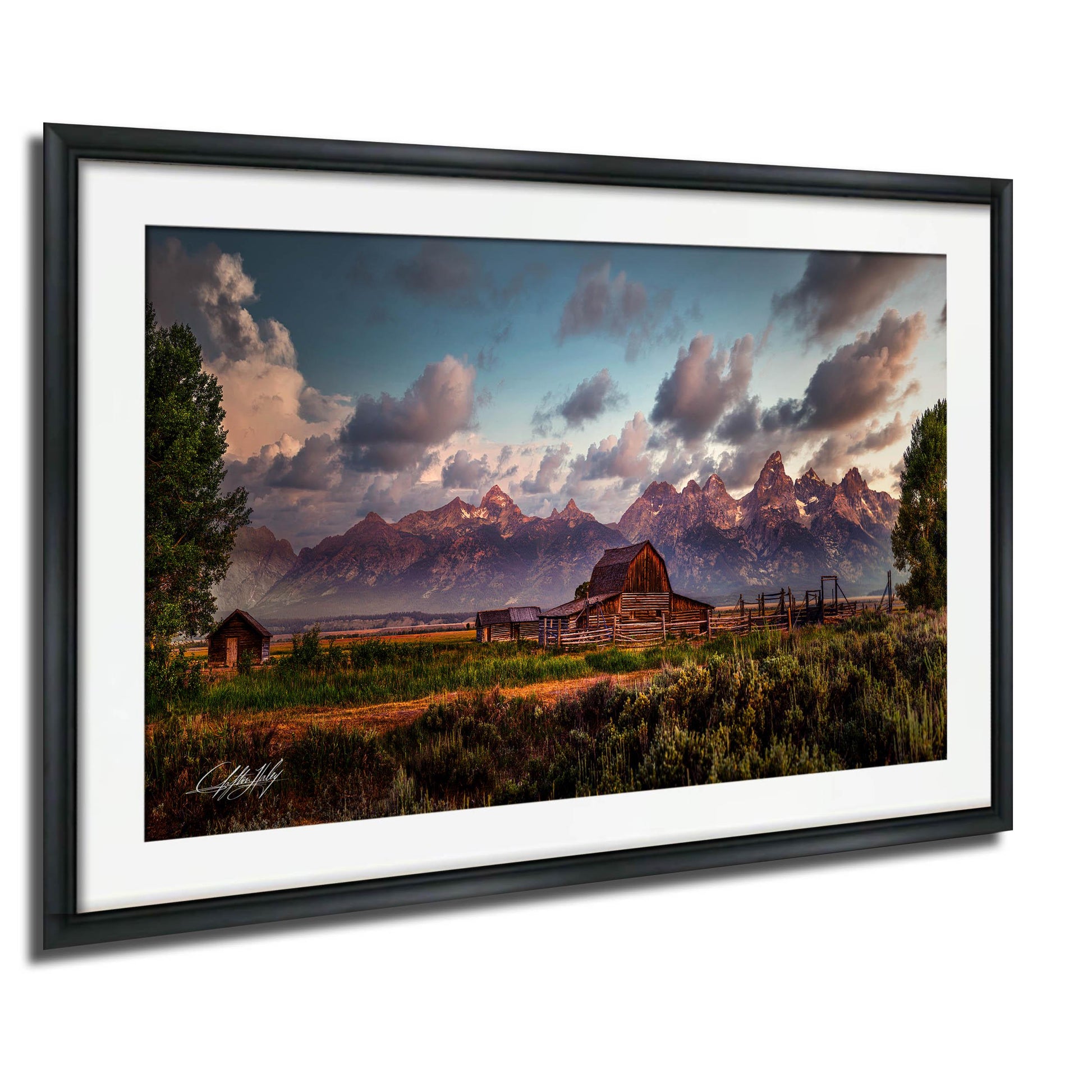 a picturesque rural landscape with a large wooden barn, a dirt road, and a mountain range in the background. The sky is filled with clouds, creating a dramatic and serene atmosphere. The overall scene conveys a sense of tranquility and natural beauty.