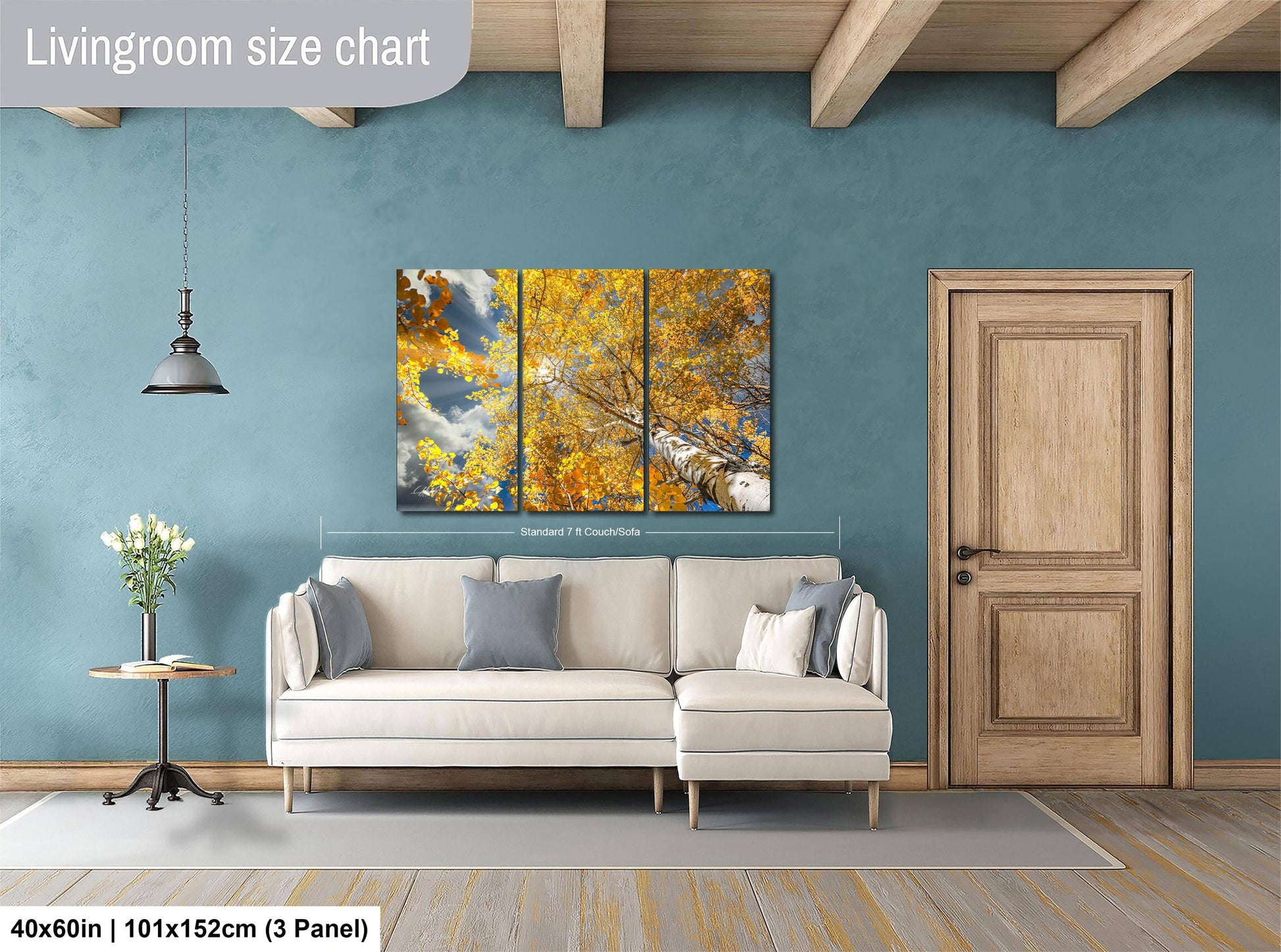 a living room with a white sofa, a wooden door, and a large painting of a tree with yellow leaves hanging on the wall.