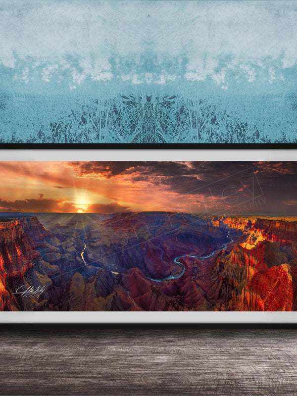 The image is a framed photograph of the Grand Canyon, showcasing the stunning landscape with vibrant colors and dramatic clouds at sunset.