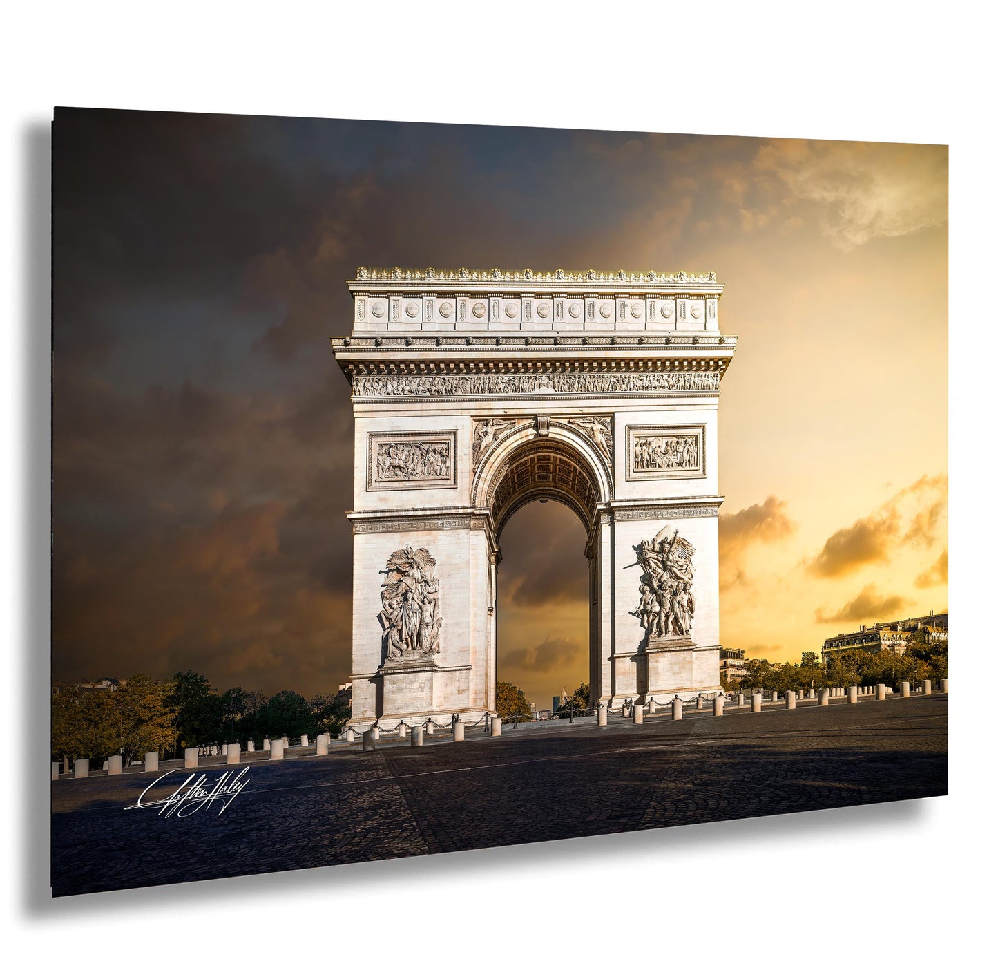 the Arc de Triomphe, a famous monument located in Paris, France. The monument is a large white arch with intricate carvings and sculptures, standing against a dramatic sky with clouds.