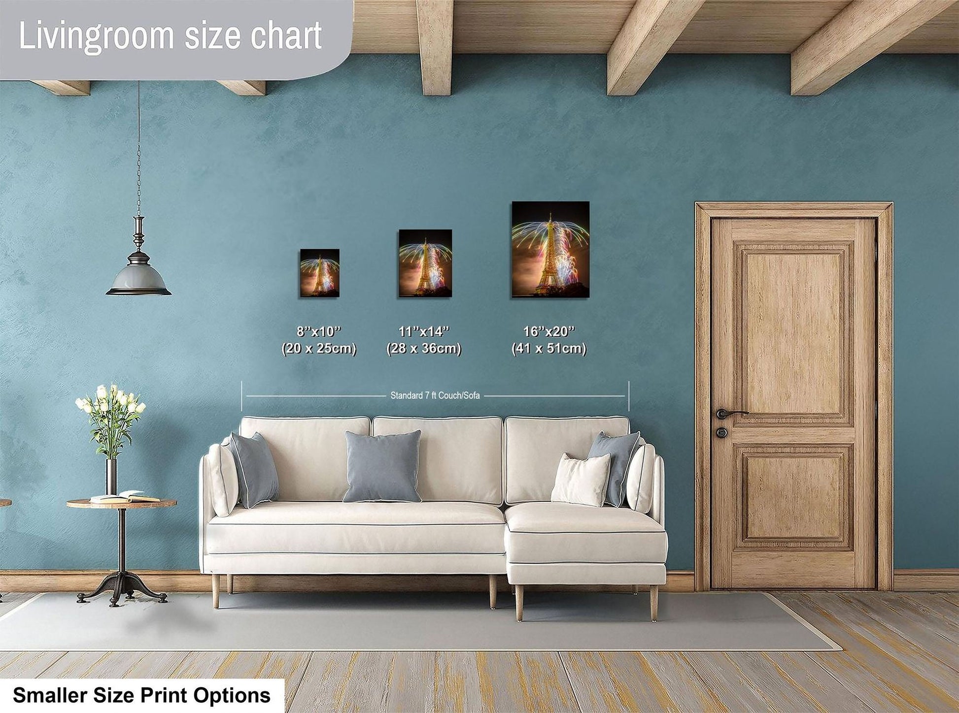 a living room with a white sofa, a wooden door, and a hanging light fixture. There are three framed artworks displayed on the wall, each with a different size and frame. The living room appears to be well-decorated and spacious.