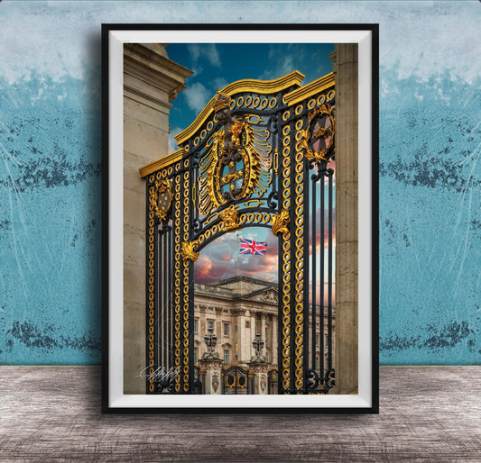 A framed photograph of a grand, ornate gate with a British flag displayed, set against a backdrop of a building with a distinctive architectural style.