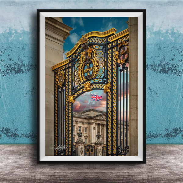 A framed photograph of a grand, ornate gate with a British flag displayed, set against a backdrop of a building with a distinctive architectural style.