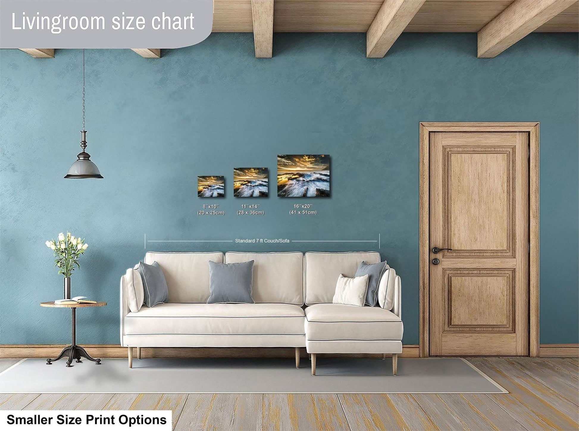 a living room with a white sofa, a wooden door, and a hanging light fixture. There are three framed artworks displayed on the wall, each with different sizes and dimensions. The living room appears to be designed for a smaller space, as indicated by the "Smaller Size Print Options" text at the bottom of the image.
