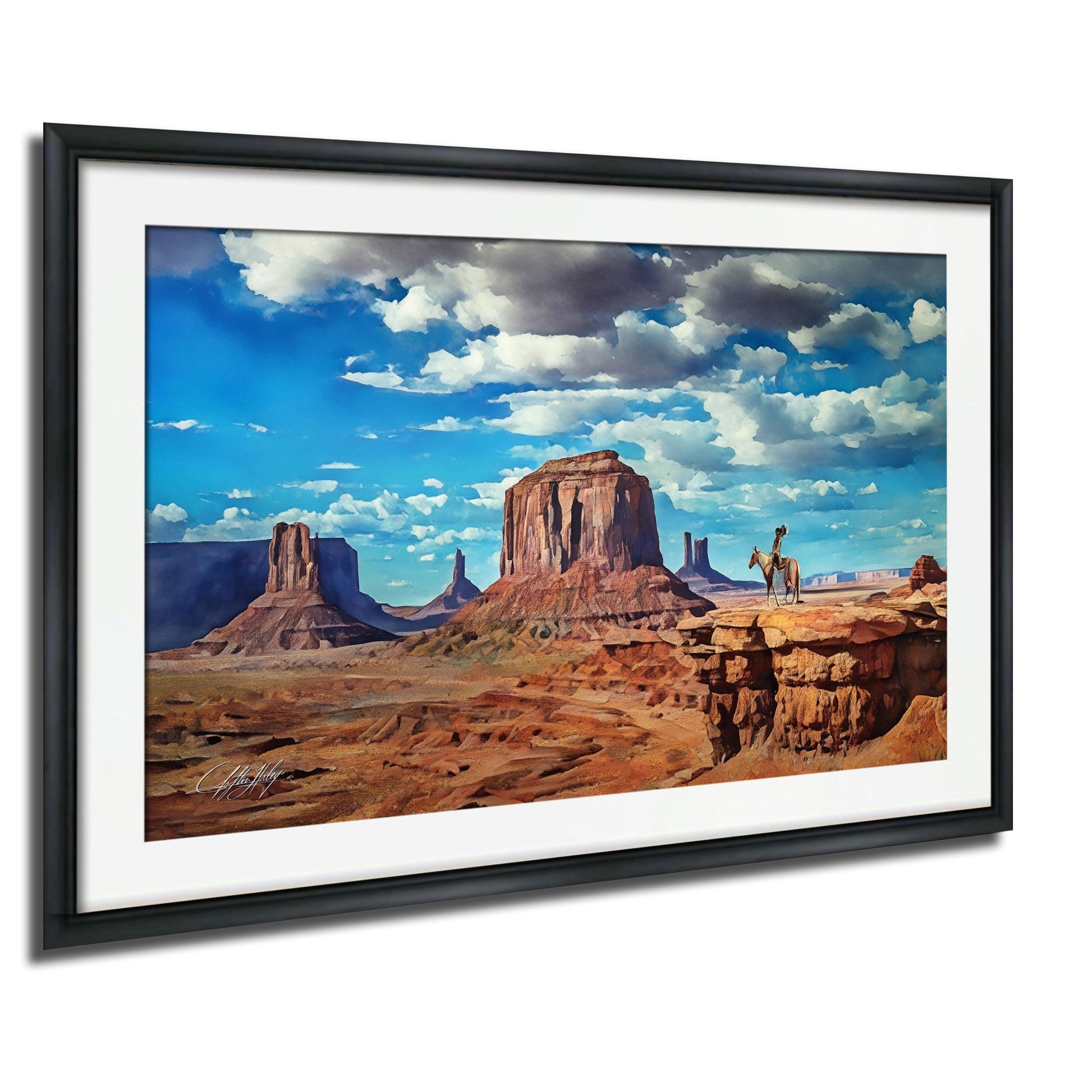 A framed painting depicting a scenic desert landscape with towering rock formations, a person riding a horse, and a cloudy blue sky.