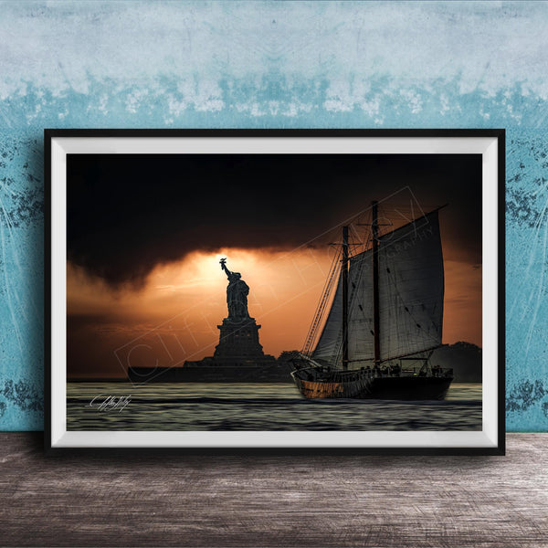 a sailboat sailing on the water, with the Statue of Liberty in the background, against a dramatic sky with a sunset.