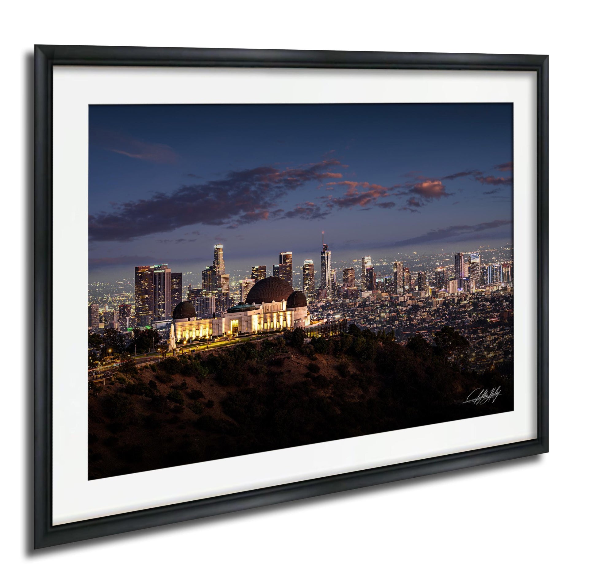 A framed photograph of the Los Angeles skyline at night, with the iconic Griffith Observatory prominently featured in the foreground.