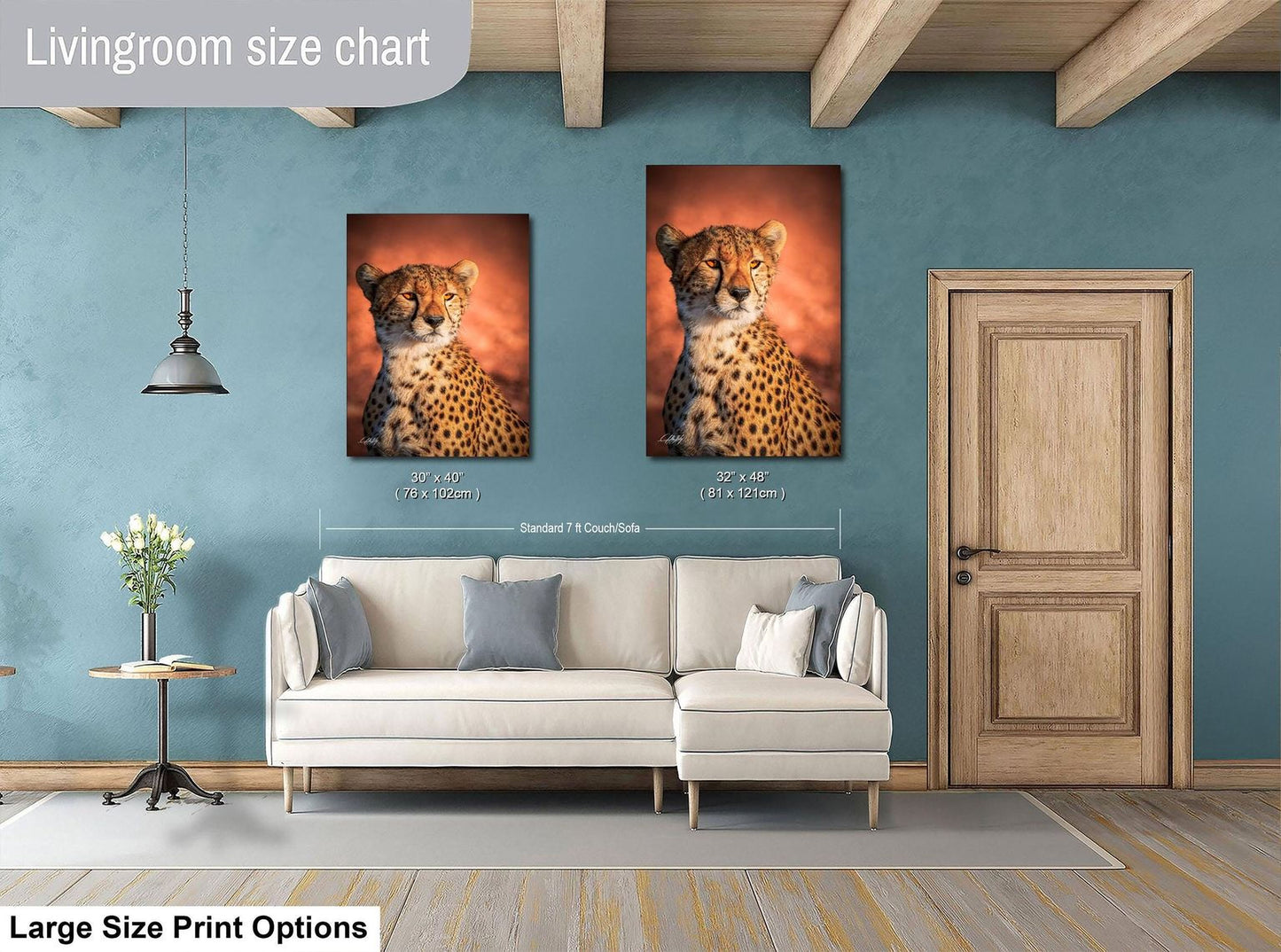 a living room with a white sofa and a wooden door. Above the sofa, there are two framed photographs of a cheetah, one larger than the other, both depicting the animal in a natural setting. The living room has a blue wall and a wooden ceiling, creating a cozy and inviting atmosphere.