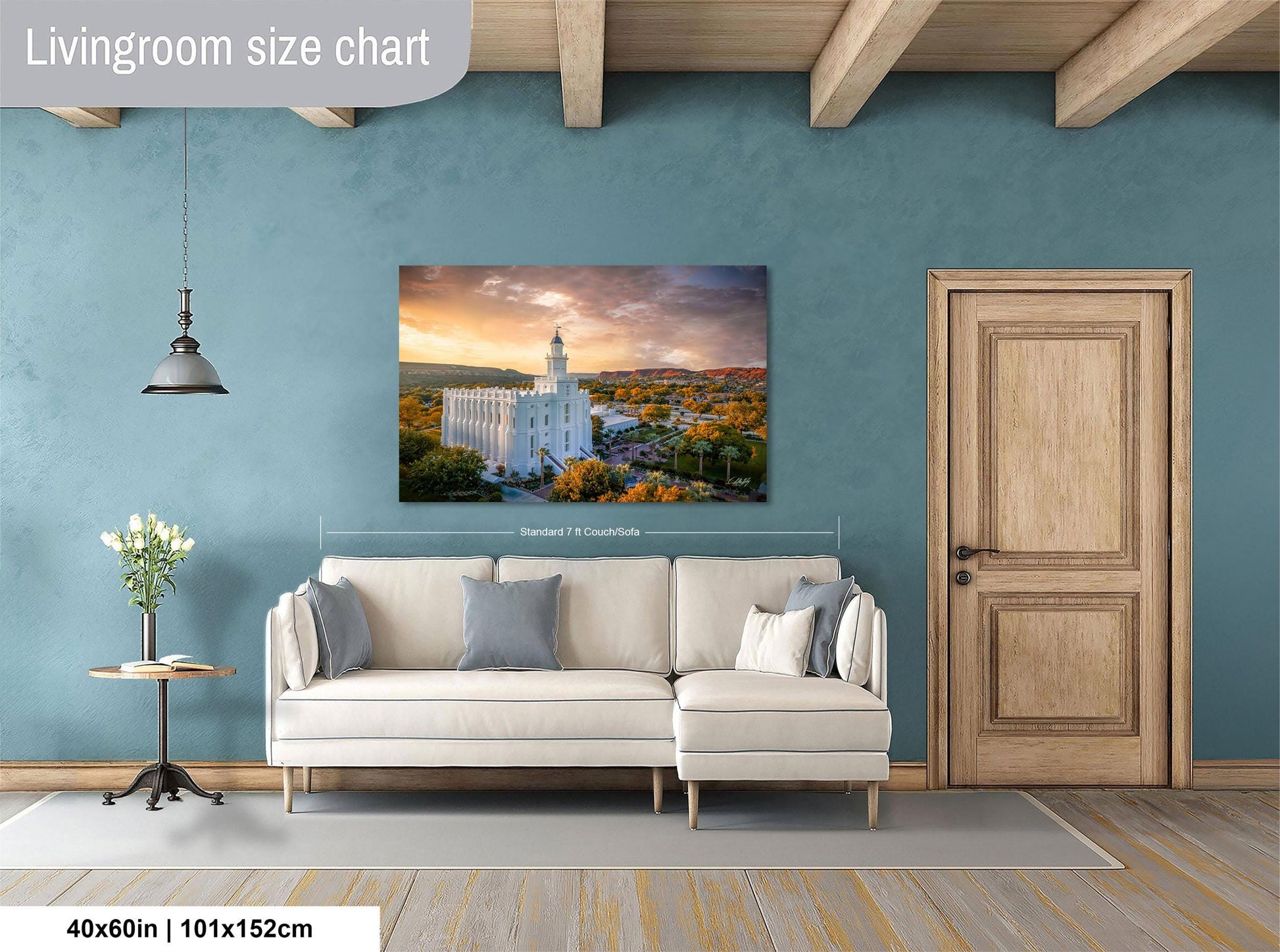 a living room with a large white sofa, a wooden door, and a painting of a temple in the background.