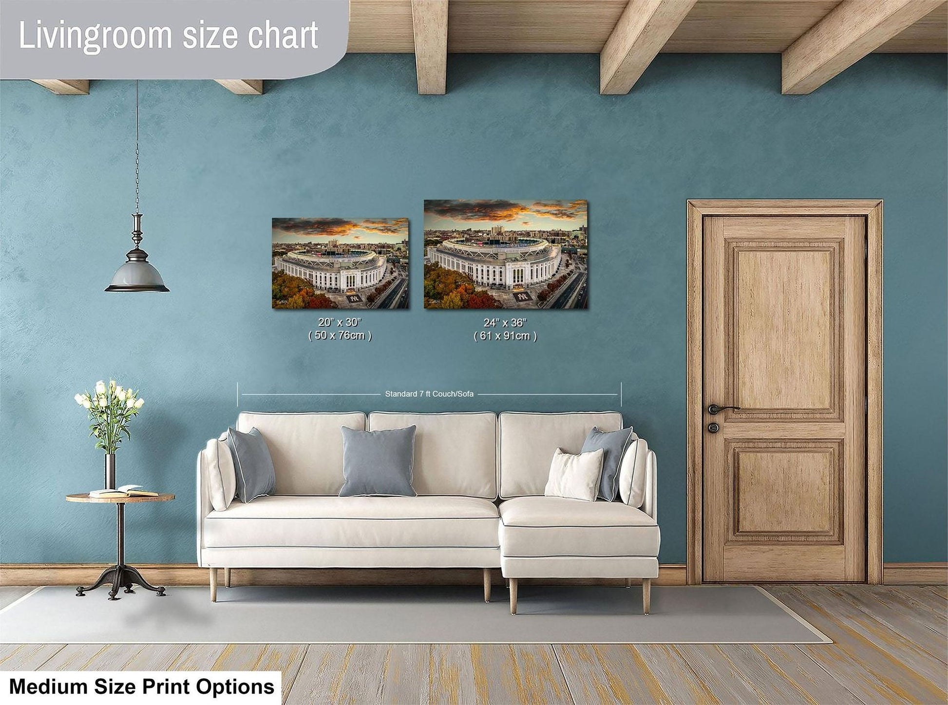a living room with a white sofa, a wooden door, and a painting of a stadium on the wall. The painting is of a stadium with a city skyline in the background. The living room appears to be well-lit and decorated with a potted plant and a vase.