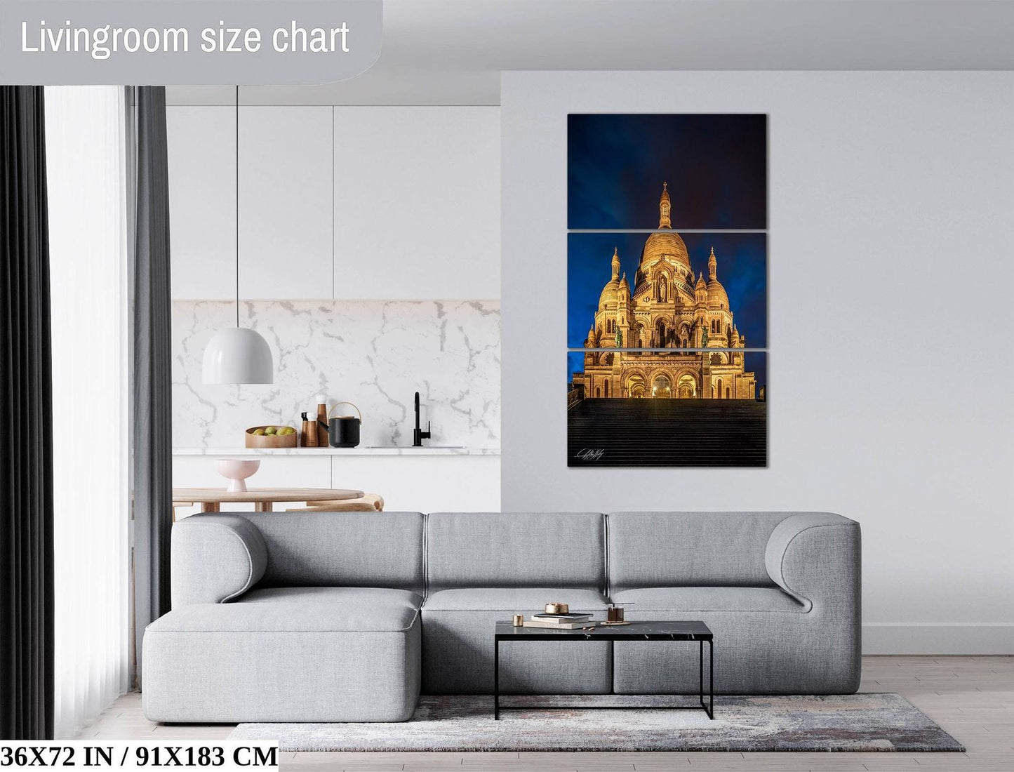 The image is a living room with a gray sofa, a coffee table, and a large painting of a cathedral in the background.