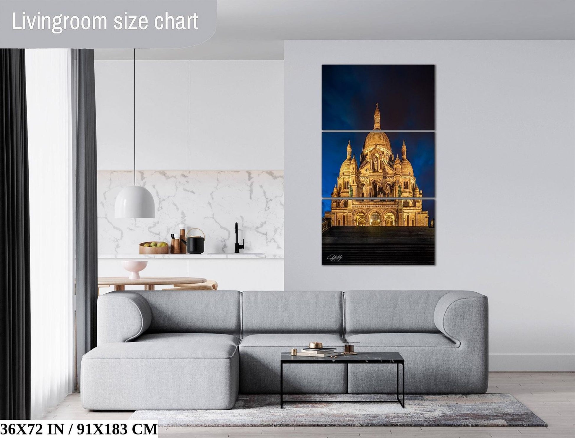 The image is a living room with a gray sofa, a coffee table, and a large painting of a cathedral in the background.