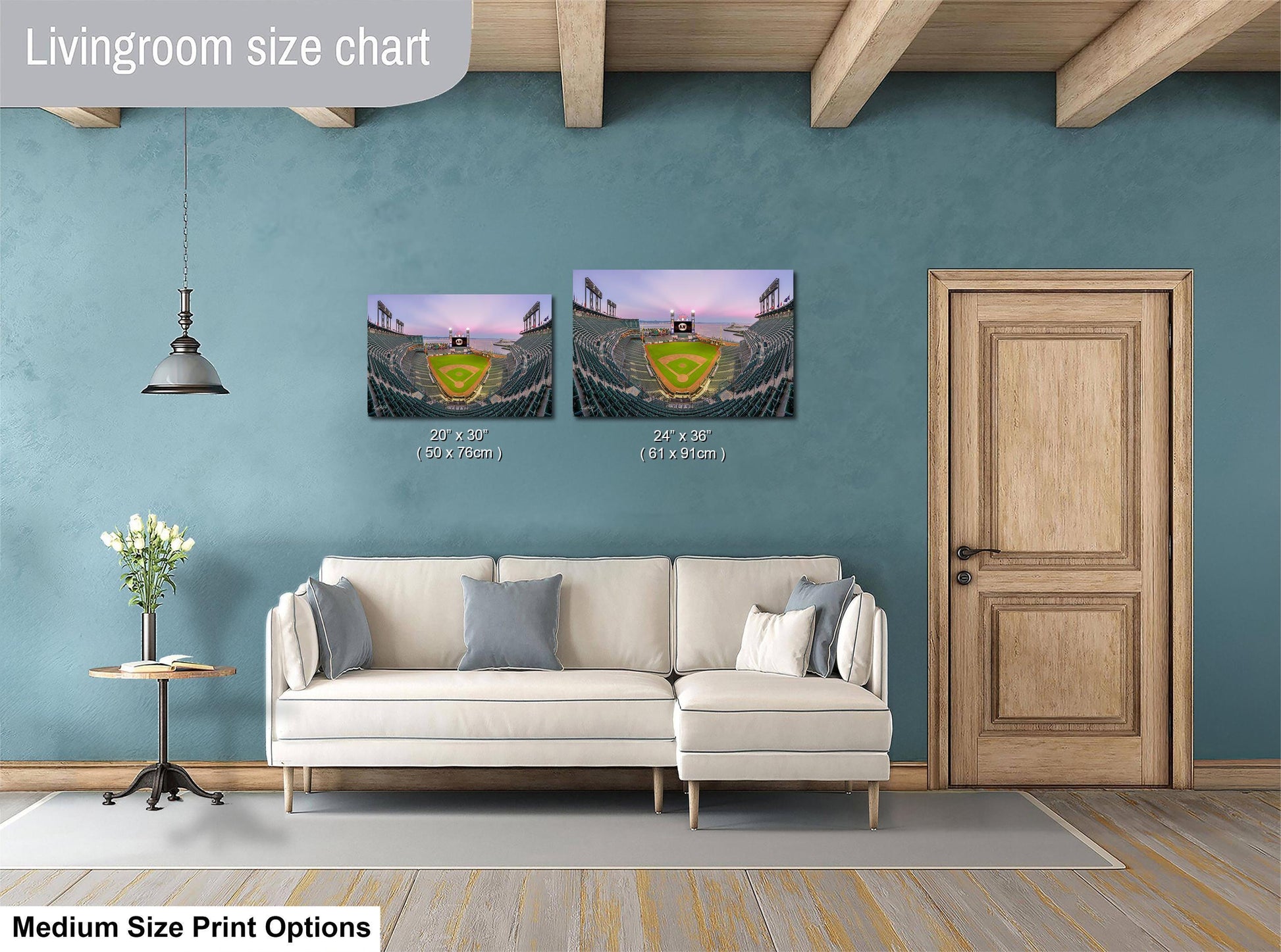 a living room with a white sofa, a wooden door, and a painting of a baseball stadium on the wall. The painting is of medium size, and the living room appears to be designed for a comfortable and relaxing atmosphere.