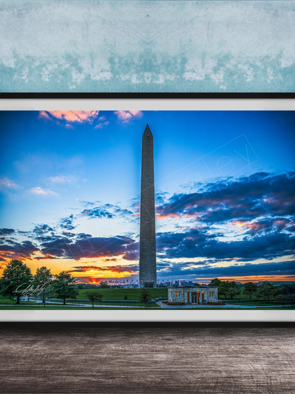 a photograph of the Washington Monument at sunset, with the sky filled with vibrant colors and clouds.