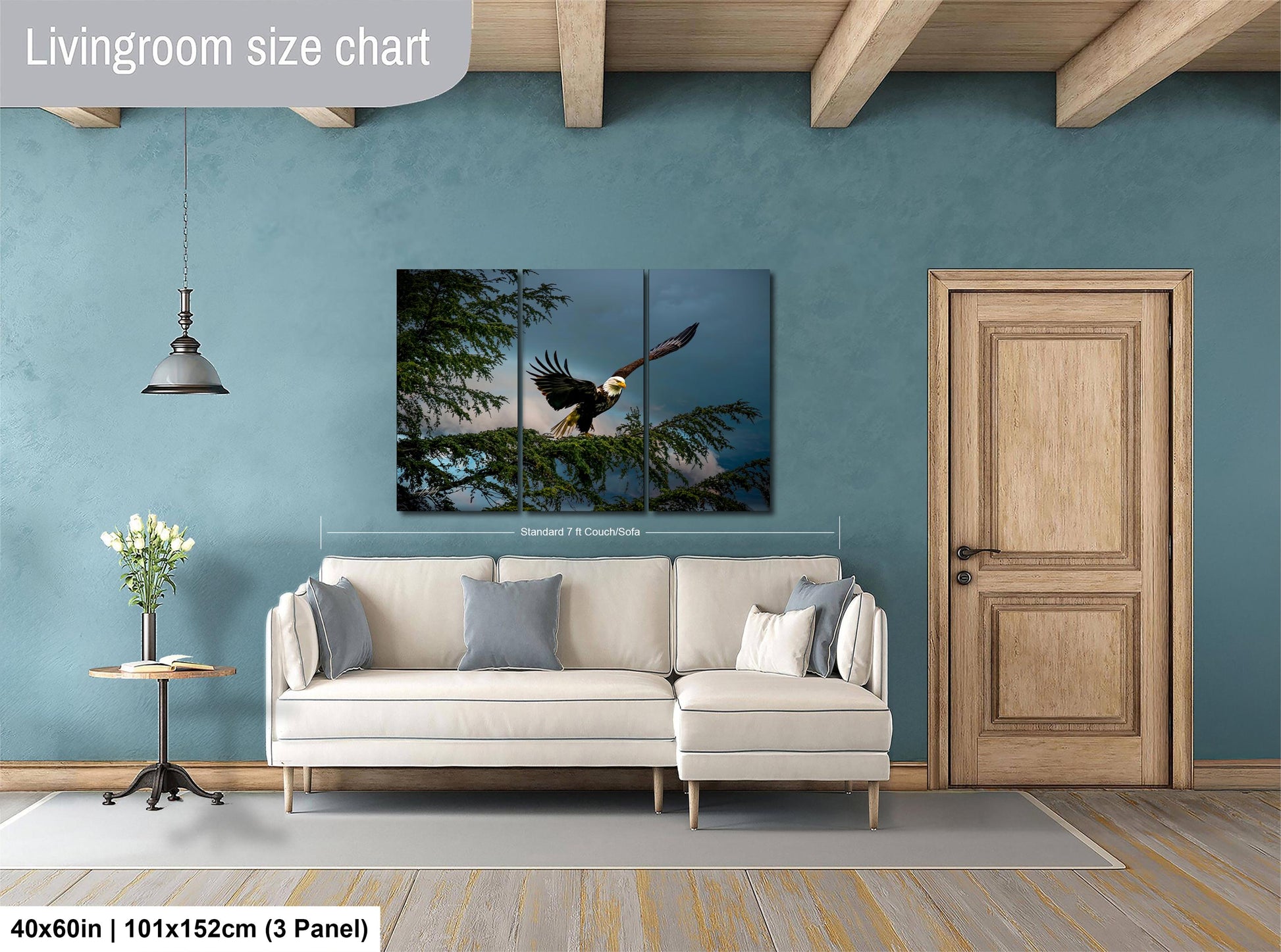 a living room with a large white sofa, a wooden door, and a painting of a bald eagle in flight hanging on the wall.