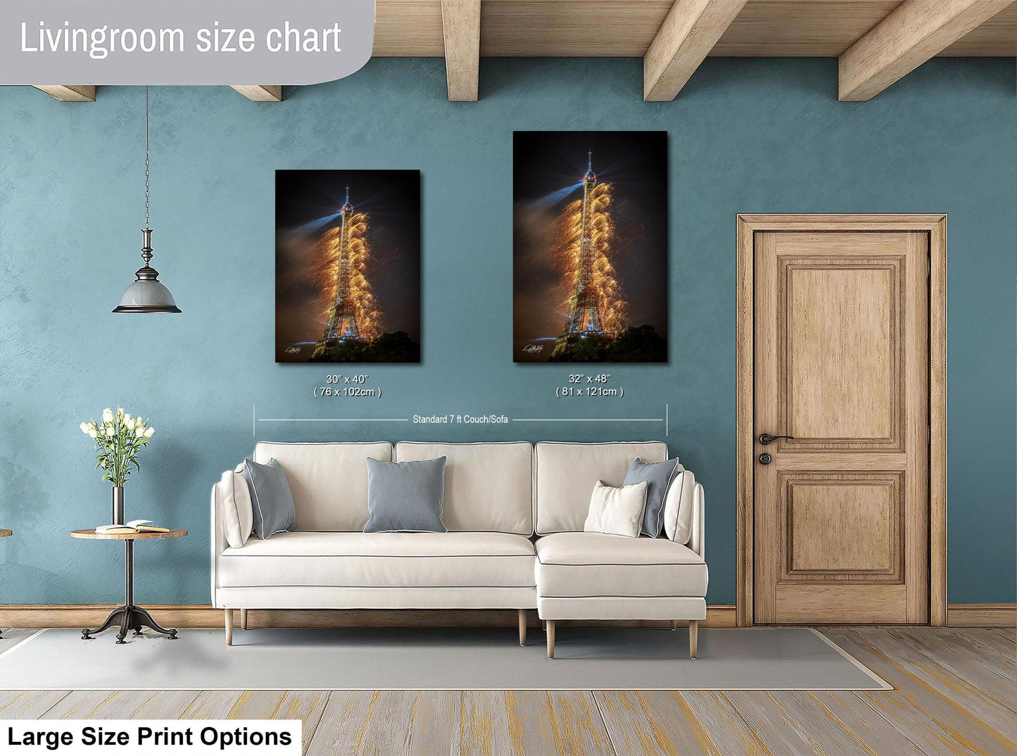a living room with a white sofa, a wooden door, and a large size print of a rocket launch on the wall.