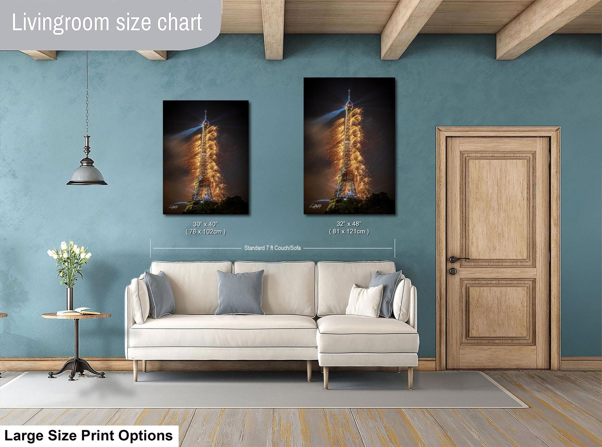 a living room with a white sofa, a wooden door, and a large size print of a rocket launch on the wall.