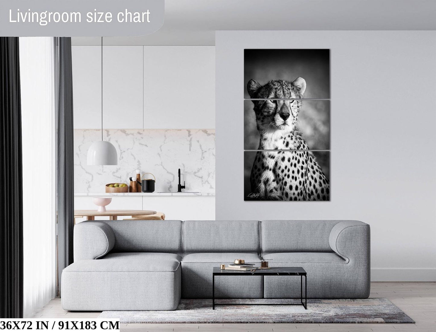 The image is a living room with a gray sofa, a coffee table, and a large black and white cheetah portrait hanging on the wall.