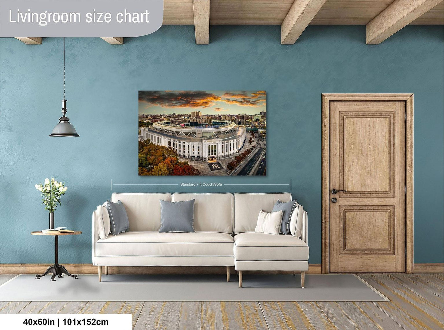 a living room with a large white sofa, a wooden door, and a painting of a stadium on the wall.