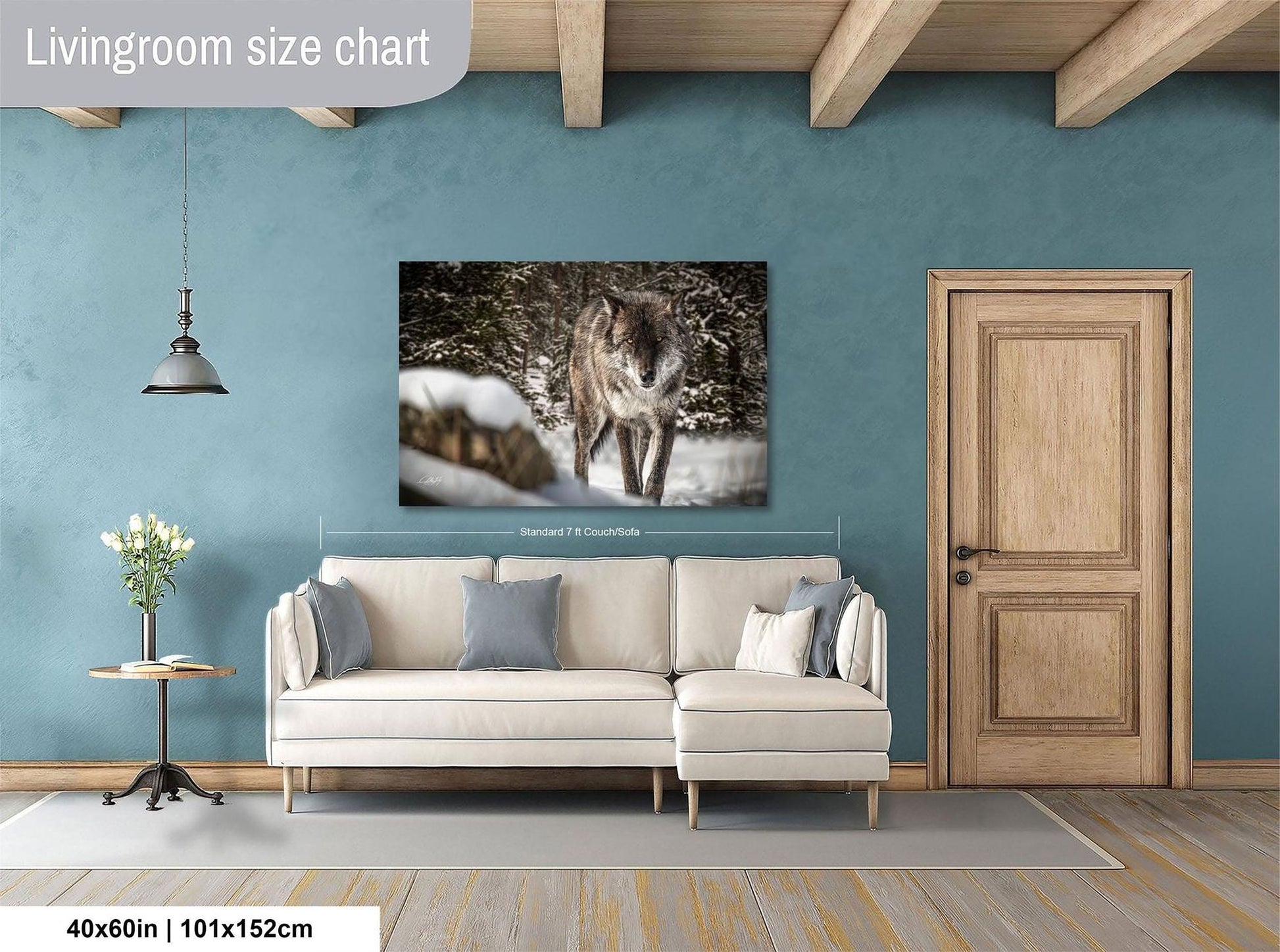 a living room with a large white sofa, a wooden door, and a framed photograph of a wolf in the background.