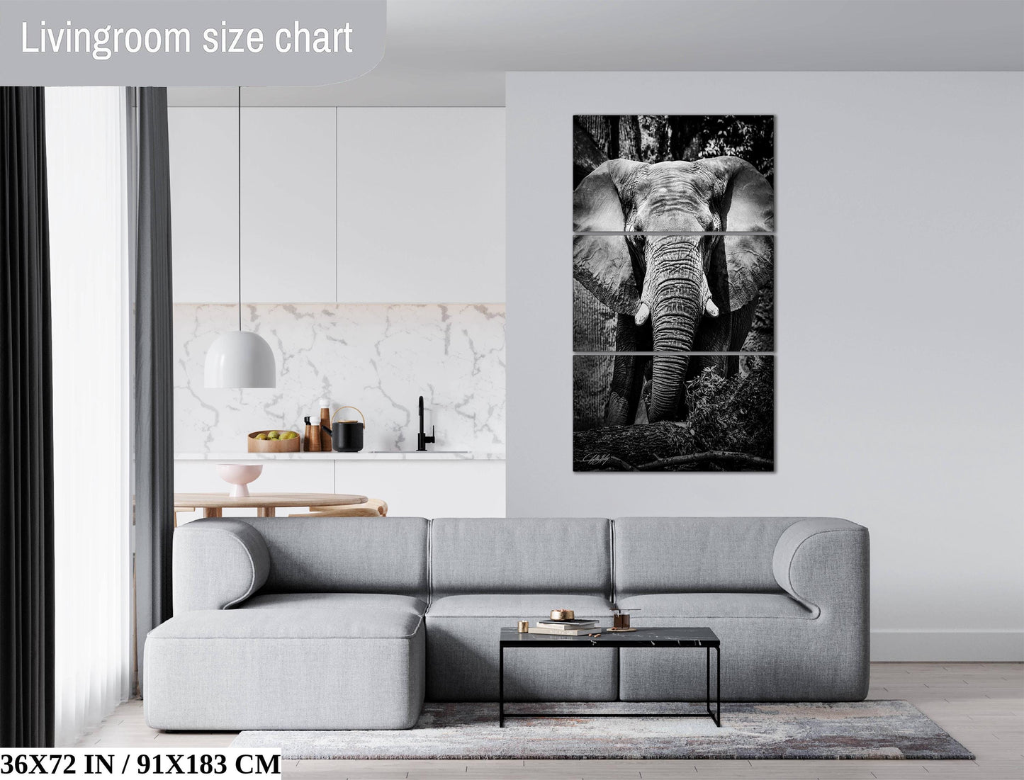 The image is a living room with a gray sofa, a coffee table, and a large black and white elephant painting on the wall.