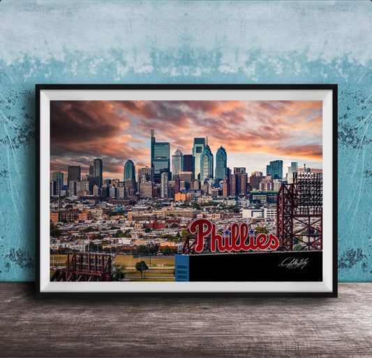 A framed photograph of the Philadelphia skyline at sunset, with the word "Phillies" prominently displayed in the foreground.