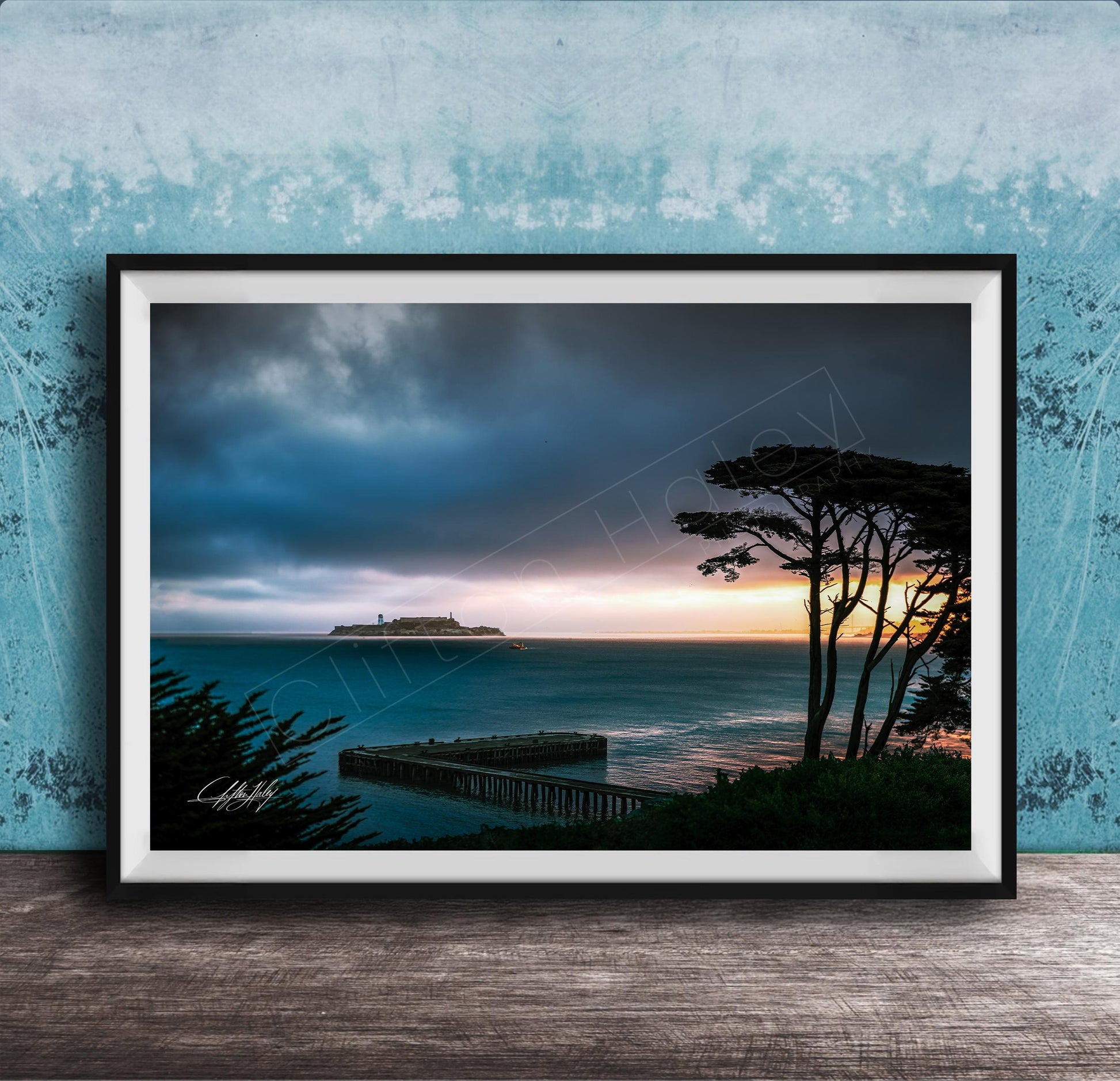 a serene coastal scene at sunset, with a wooden pier extending into the calm, blue waters. The sky is filled with clouds, creating a dramatic backdrop for the tranquil setting.