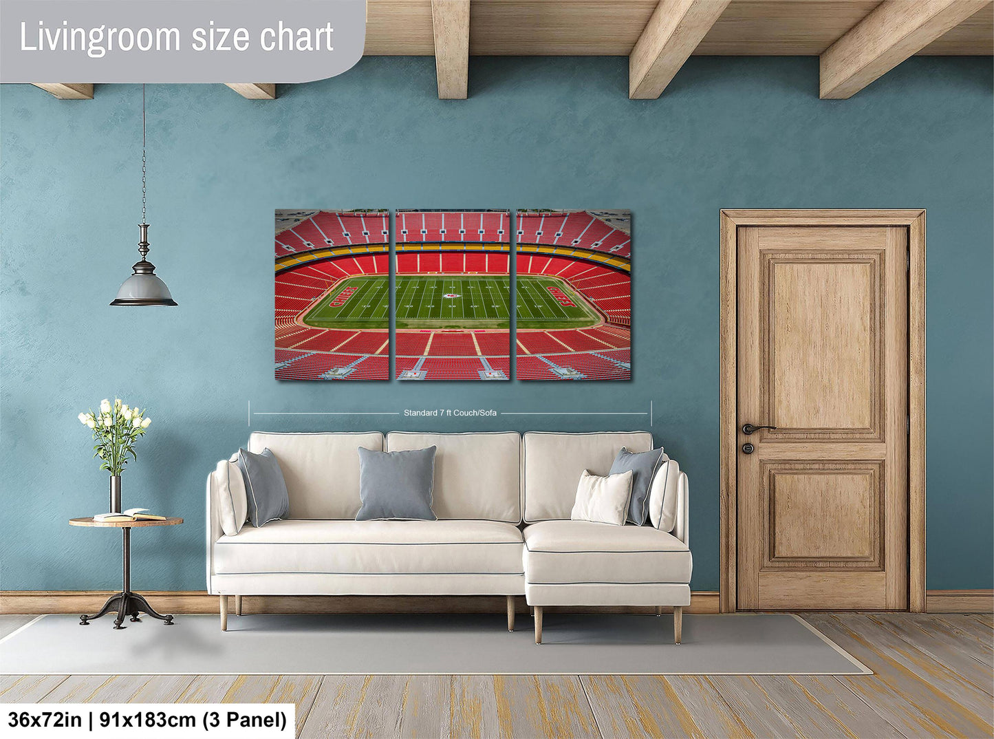 a living room with a large, colorful painting of a stadium on the wall. The painting is divided into three panels, depicting the seating area, the field, and the roof. The room has a white sofa and a wooden door, and the floor is covered with a gray rug.