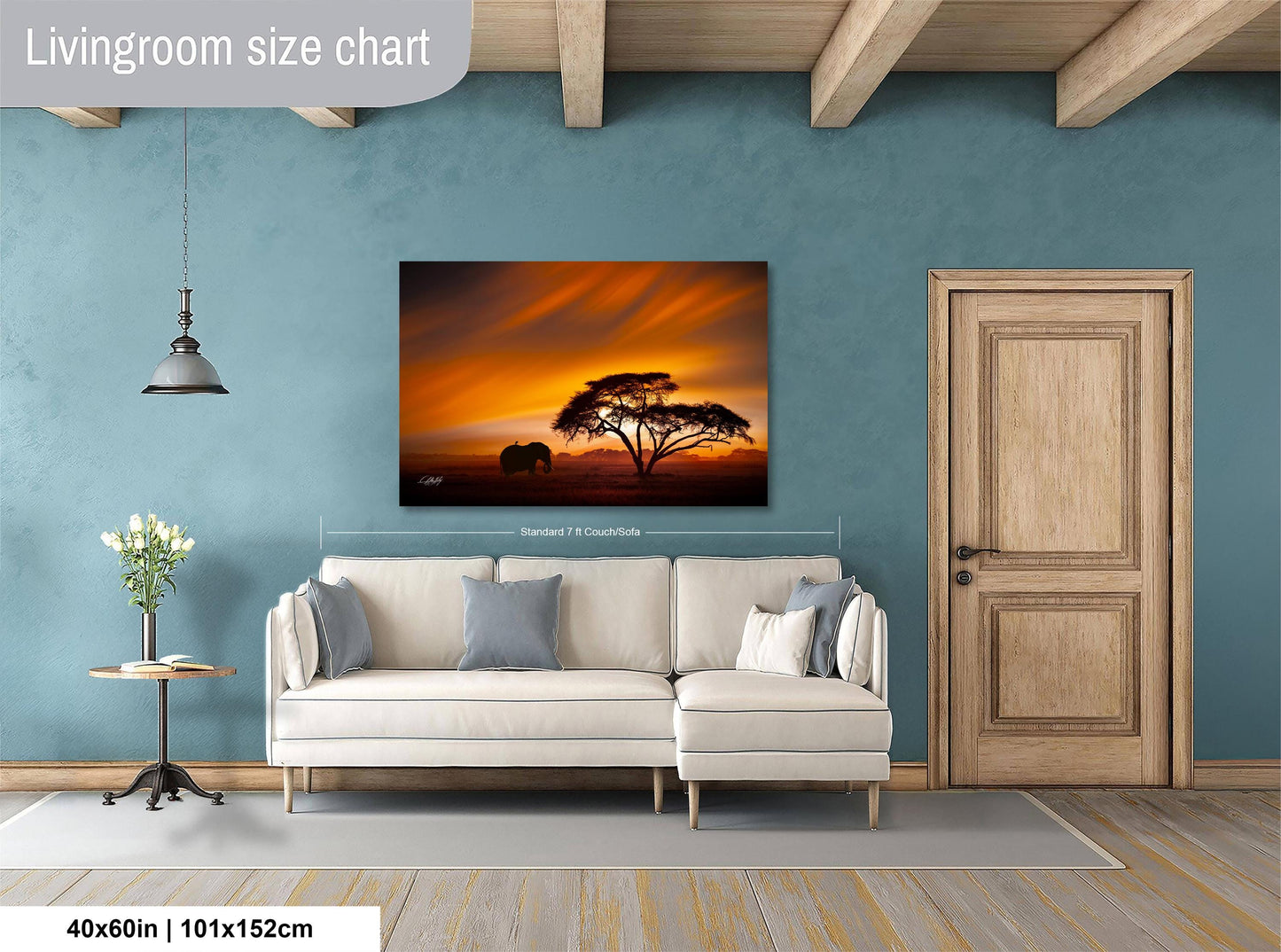 a living room with a large painting of a tree and an elephant in the background, hanging on the wall. The painting is framed in a white frame and measures 40 inches by 101.5 centimeters.
