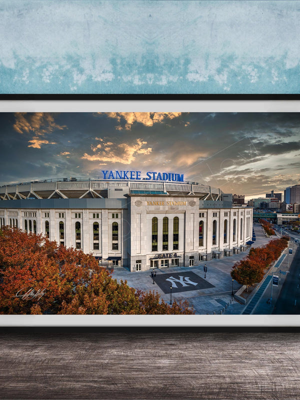 A framed photograph of Yankee Stadium, a baseball stadium located in New York City, with the stadium's name prominently displayed on the exterior.